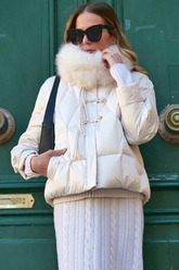 a lady in a white coat and a long white sweater dress